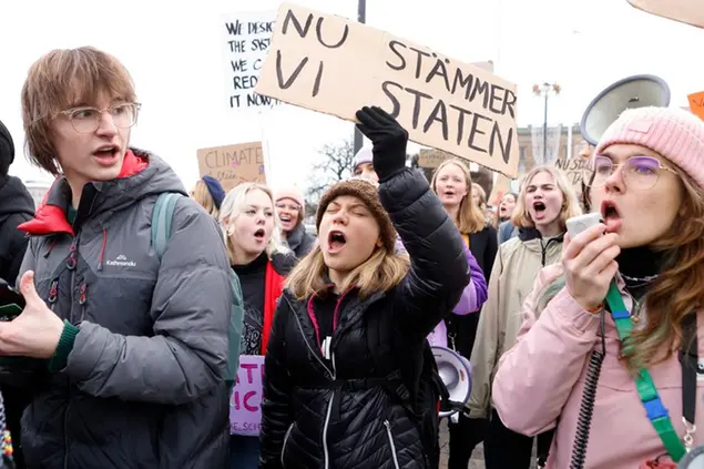 Climate activist Greta Thunberg, center, attends a demonstration by youth-led organization Auroras, in Stockholm, Sweden, Friday, Nov. 25, 2022. Writing on cardboard reads in Swedish \\\"Now we sue the State\\\" (Christine Ohlsson/TT News Agency via AP) Associated Press/LaPresse Only Italy and Spain