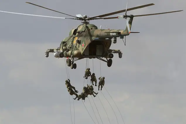 FILE - Soldiers abseil from a military helicopter over the training ground during strategic command and staff exercises Center-2019 at Donguz shooting range near Orenburg, Russia, Sept. 20, 2019. The main theme of the drills is the use of a coalition army group in the fight against international terrorism and providing military security in Central Asia. Servicemen from Russia, Kazakhstan, Kyrgyzstan, Tajikistan, Uzbekistan, India, China and Pakistan are taking part in the drills. Amid the soaring tensions over Ukraine, President Vladimir Putin is heading to Beijing on a trip intended to help strengthen Russia's ties with China and coordinate their policies amid Western pressure. (AP Photo/Sergei Grits, file)