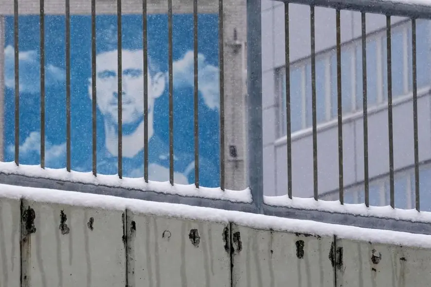 A billboard depicting Serbian tennis player Novak Djokovic on a building in Belgrade, Serbia, Monday, Jan. 10, 2022. Tennis star Novak Djokovic on Monday won a court battle to stay in Australia to contest the Australian Open despite being unvaccinated against COVID-19, but the government threatened to cancel his visa a second time. Federal Circuit Court Judge Anthony Kelly reinstated Djokovic's visa, which was canceled after his arrival last week because officials decided he didn't meet the criteria for an exemption to an entry requirement that all non-citizens be fully vaccinated. (AP Photo/Darko Vojinovic)