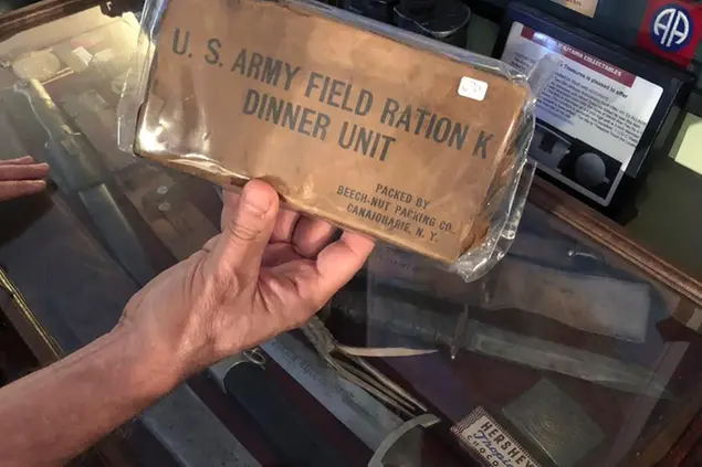 HOLD FOR STORY BY JENNIFER MCDERMOTT -- In this June 22, 2018 photo, filmmaker Tim Gray holds a U.S. Army dinner unit, or K-ration, from World War II. It is one of many items destined for a planned World War II education center in Wakefield, R.I. Gray, founder of the nonprofit World War II Foundation, plans to open the center in September. (AP Photo/Jennifer McDermott)