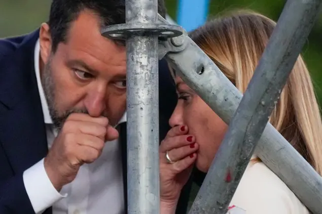 The League's Matteo Salvini, left, chats with Brothers of Italy's Giorgia Meloni on the stage of the center-right coalition closing rally in Rome Thursday, Sep. 22, 2022. Italians will vote on Sunday in what is billed as a crucial election on a continent reeling from the repercussions of the war in Ukraine. For the first time in Italy since the end of World War II, the balloting's outcome could propel into the premiership Giorgia Meloni, a leader with a far-right agenda. (AP Photo/Gregorio Borgia)