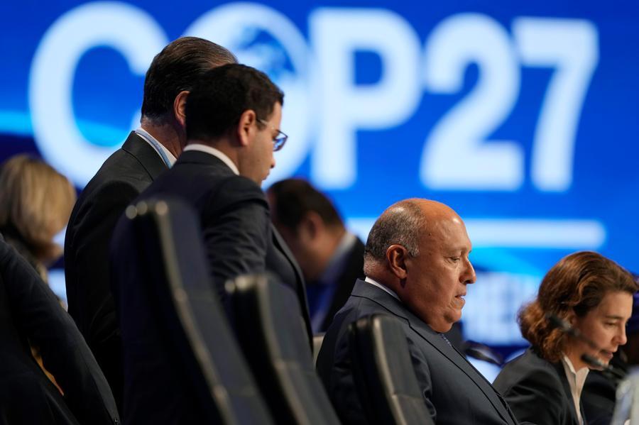 Sameh Shoukry, president of the COP27 climate summit, right, talks with others at a closing plenary session at the U.N. Climate Summit, Sunday, Nov. 20, 2022, in Sharm el-Sheikh, Egypt. (AP Photo/Peter Dejong)