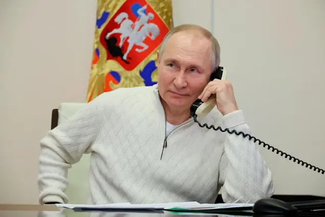 Russian President Vladimir Putin speaks on the phone to seven-year-old David Shmelev from Stavropol Krai region, a participant of the Fir Tree of Wishes charity campaign via videoconference from the Novo-Ogaryovo residence outside Moscow, Russia, Thursday, Jan. 5, 2023. (Mikhail Klimentyev, Sputnik, Kremlin Pool Photo via AP)