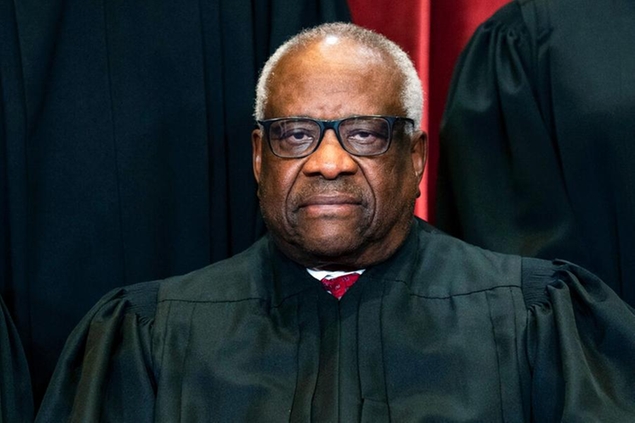 Associate Justice Clarence Thomas sits during a group photo at the Supreme Court in Washington, Friday, April 23, 2021. (Erin Schaff/The New York Times via AP, Pool)