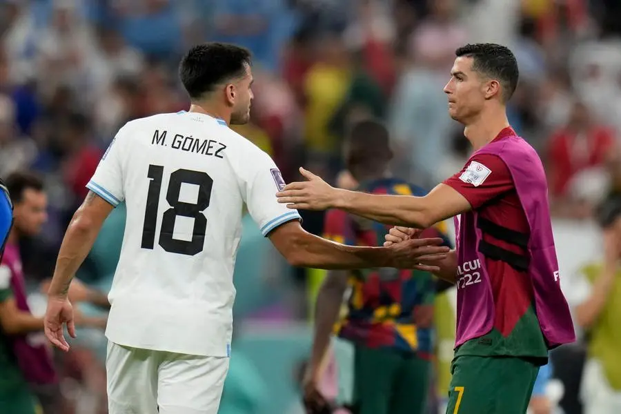 Portugal's Cristiano Ronaldo greets Uruguay's Maxi Gomez after Portugal won the World Cup group H soccer match between Portugal and Uruguay, at the Lusail Stadium in Lusail, Qatar, Monday, Nov. 28, 2022. (AP Photo/Aijaz Rahi)