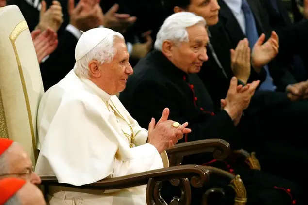 FILE - In this Saturday, Oct. 27, 2007 file photo Pope Benedict XVI and his brother Georg, right, attend a concert by the Symphonic Orchestra Bayerischer Rundfunk and the Bamberger Symphoniker at the Paul VI Hall at the Vatican. The Rev. Georg Ratzinger, the older brother of Emeritus Pope Benedict XVI, who earned renown in his own right as a director of an acclaimed German boys’ choir, has died at age 96. The Regensburg diocese in Bavaria, where Ratzinger lived, said in a statement on his website that he died on Tuesday, June 30, 2020. (AP Photo/Andrew Medichini, File)