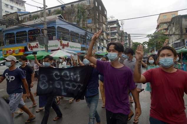 Anti-coup protesters flash the three-finger salute during a demonstration against the military takeover, in Yangon, Myanmar, Monday, May 24, 2021. (AP Photo)