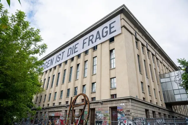 07 July 2021, Berlin: \\\"Tomorrow is the question\\\" is written on a huge banner on the building of the techno club Berghain. From 10.07.2021, people will be allowed to dance in Berlin's legendary club again, albeit only in the open air for the time being. Admission will only be granted to those who have been vaccinated, recovered or tested negative. Photo by: Christophe Gateau/picture-alliance/dpa/AP Images