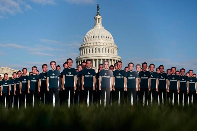 FILE - In this April 10, 2018, file photo, life-sized cutouts depicting Facebook CEO Mark Zuckerberg wearing \\\"Fix Fakebook\\\" T-shirts are displayed by advocacy group, Avaaz, on the South East Lawn of the Capitol on Capitol Hill in Washington, ahead of Zuckerberg's appearance before a Senate Judiciary and Commerce Committees joint hearing. Federal regulators asked Wednesday, Dec. 9, 2020, for Facebook to be ordered to divest its Instagram and WhatsApp messaging services as the U.S. government and 48 states and districts accused the company of abusing its market power in social networking to crush smaller competitors. The antitrust lawsuits were announced by the Federal Trade Commission and New York Attorney General Letitia James. (AP Photo/Carolyn Kaster, File)