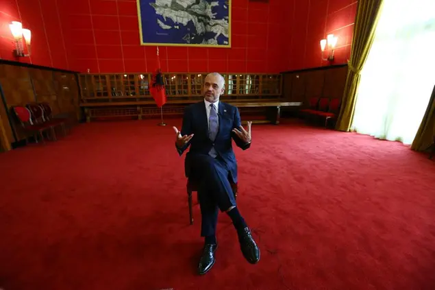 Albanian Prime Minister Edi Rama speaks during an interview with The Associated Press at his office in Tirana, Wednesday, Oct. 22, 2014. Albania\\u2019s prime minister has told the Associated Press that a heated spat with Serbia over a soccer match triggered by drone would not derail a common effort to seek faster European Union membership. (AP Photo/Hektor Pustina)