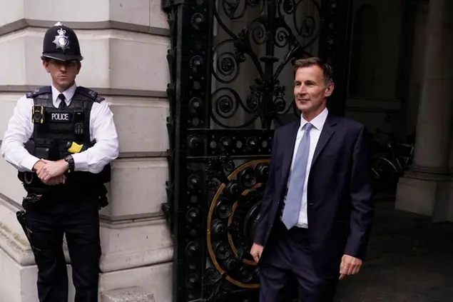 Britain's new Treasury Chief Jeremy Hunt arrives in Downing Street to see the Prime Minister Liz Trus, in London, Friday, Oct. 14, 2022. Embattled British Prime Minister Liz Truss sacked her former Treasury chief Kwasi Kwarteng and reversed course on sweeping tax cuts Friday as she tried to hang on to her job after weeks of turmoil on financial markets.(AP Photo/Alberto Pezalli)