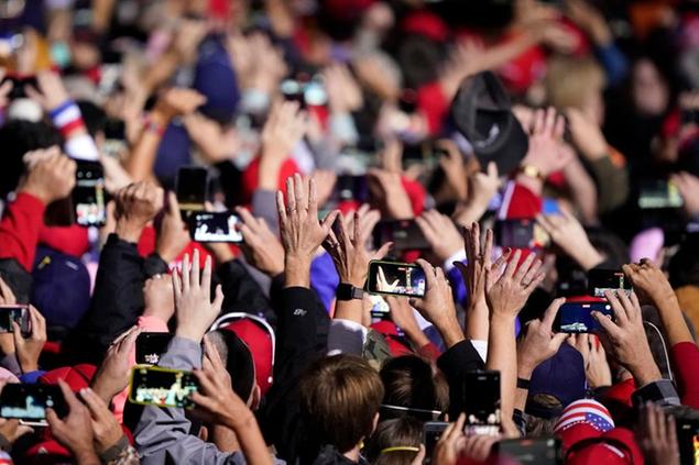 Supporters cheer and take photos as President Donald Trump arrives to speak at a campaign rally on Sunday, Nov. 1, 2020, at Hickory Regional Airport in Hickory, N.C. (AP Photo/Chris Carlson)