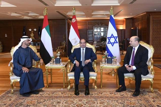 In this photo provided by the Egyptian Presidency Media Office, Egyptian President Abdel-Fattah el-Sissi, center, meets with Abu Dhabi Crown Prince Sheikh Mohammed bin Zayed Al Nahyan, left, and Israeli Prime Minister Naftali Bennett in the Red Sea resort of Sharm el-Sheikh, Egypt, Tuesday, March 22, 2022. (Egyptian Presidency Media Office via AP)