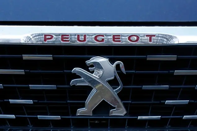 FILE - In this Wednesday, Dec.18, 2019 file photo, he logo of the French car maker Peugeot is pictured in Paris. Fiat Chrysler and PSA Peugeot on Wednesday, Oct. 28, 2020 confirmed progress toward their full merger to create the globe’s fourth-largest carmaker, with completion expected by the end of March 2021. (AP Photo/Thibault Camus, file)