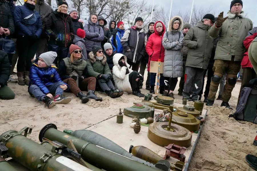Civilians listens to an instructor during a training of members of a Ukrainian far-right group train, in Kyiv, Ukraine, Sunday, Feb. 20, 2022. Russia extended military drills near Ukraine\\\\'s northern borders Sunday amid increased fears that two days of sustained shelling along the contact line between soldiers and Russa-backed separatists in eastern Ukraine could spark an invasion. (AP Photo/Efrem Lukatsky)