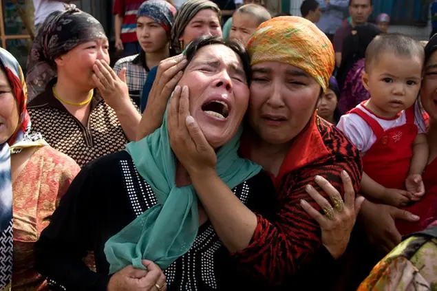 Uighur women grieve for their men who they claim were taken away by Chinese authorities after Sunday's protest in Urumqi, China, Tuesday, July 7 , 2009. Urumqi was tense Tuesday, with protests happening in several parts of the city and both Han Chinese and Uighur groups facing off with armed police. (AP Photo/Ng Han Guan)