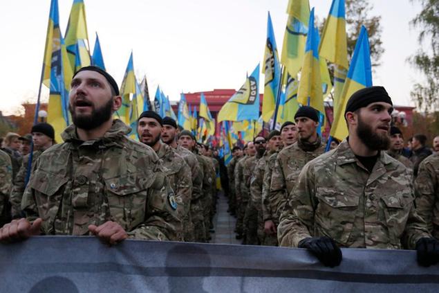 Fighters from the Azov volunteer battalion shout slogans during the march marking the 72nd anniversary of the Ukrainian Insurgent Army in Kiev, Ukraine, Tuesday, Oct. 14, 2014. The Ukrainian Insurgent Army initially collaborated with the Nazis, believing Hitler would grant Ukraine independence, but then went on to fight both Nazi forces and the Red Army. (AP Photo/Sergei Chuzavkov)