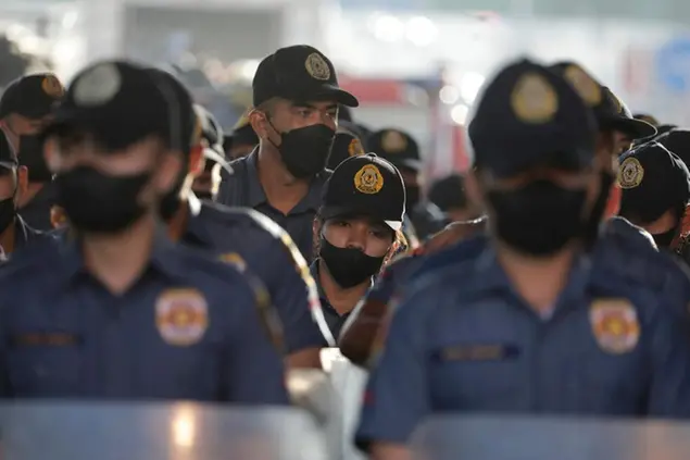 Police personnel stand in formation along the main road leading to the House of Representatives ahead of the State of the Nation address by the country's new president Ferdinand Marcos Jr. in Quezon city, Philippines Monday, July 25, 2022. (AP Photo/Gerard Carreon)