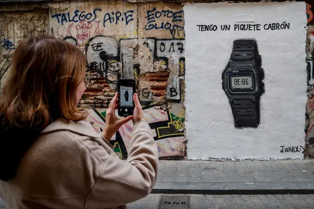 A woman takes a photo of graffiti on a Casio watch with the text 'tengo un piquete cabrón' after Shakira's song to Piqué, on January 16, 2023, in Valencia, Valencian Community (Spain). Shakira has reached the best Latin premiere on YouTube with more than 33 million plays in less than 24 hours, surpassing the platform's record held until this moment by 'Despacito' by Luis Fonsi. Session 53' with Bizarrap is trending number one on Youtube Spain . 16 JANUARY 2023;VALENCIA;VALENCIAN ARTIST J.WARX;GRAFFITI;SONG;BIZARRAP;SHAKIRA;PIQUÉ Rober Solsona / Europa Press 01/16/2023 (Europa Press via AP)